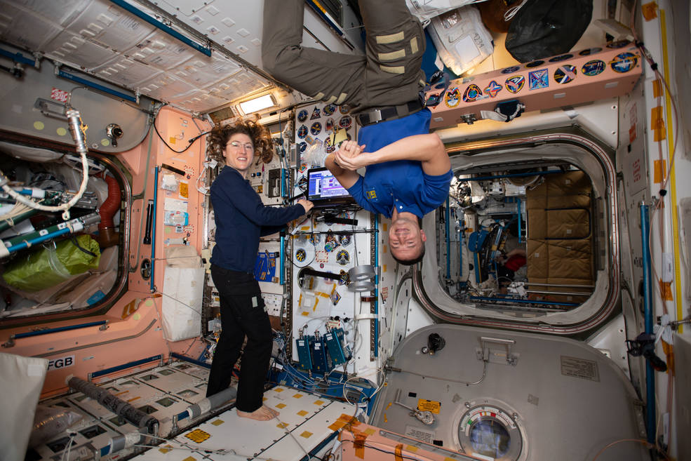 Two astronauts floating In International Space Station